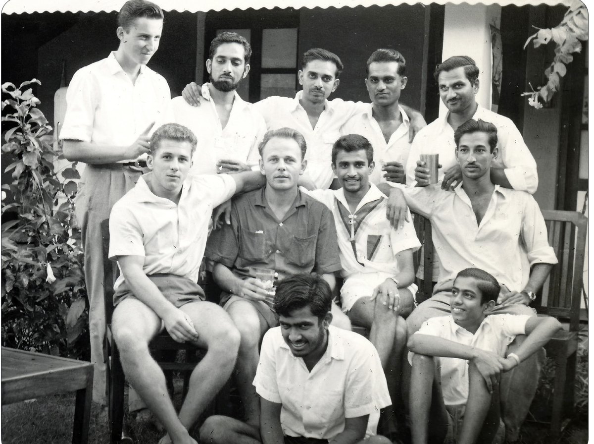Group photograph with Promesse and Victor seated on the floor