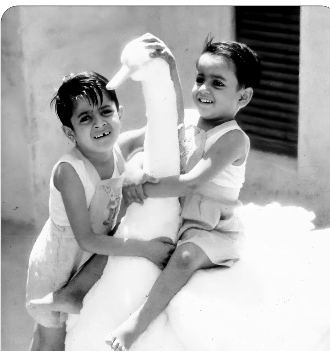 Victor and Promesse playing with a cotton-wool duck