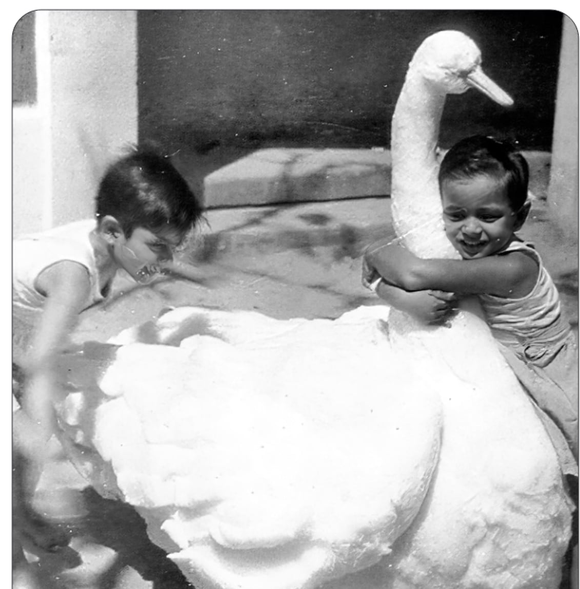 Victor and Promesse playing with a cotton-wool duck