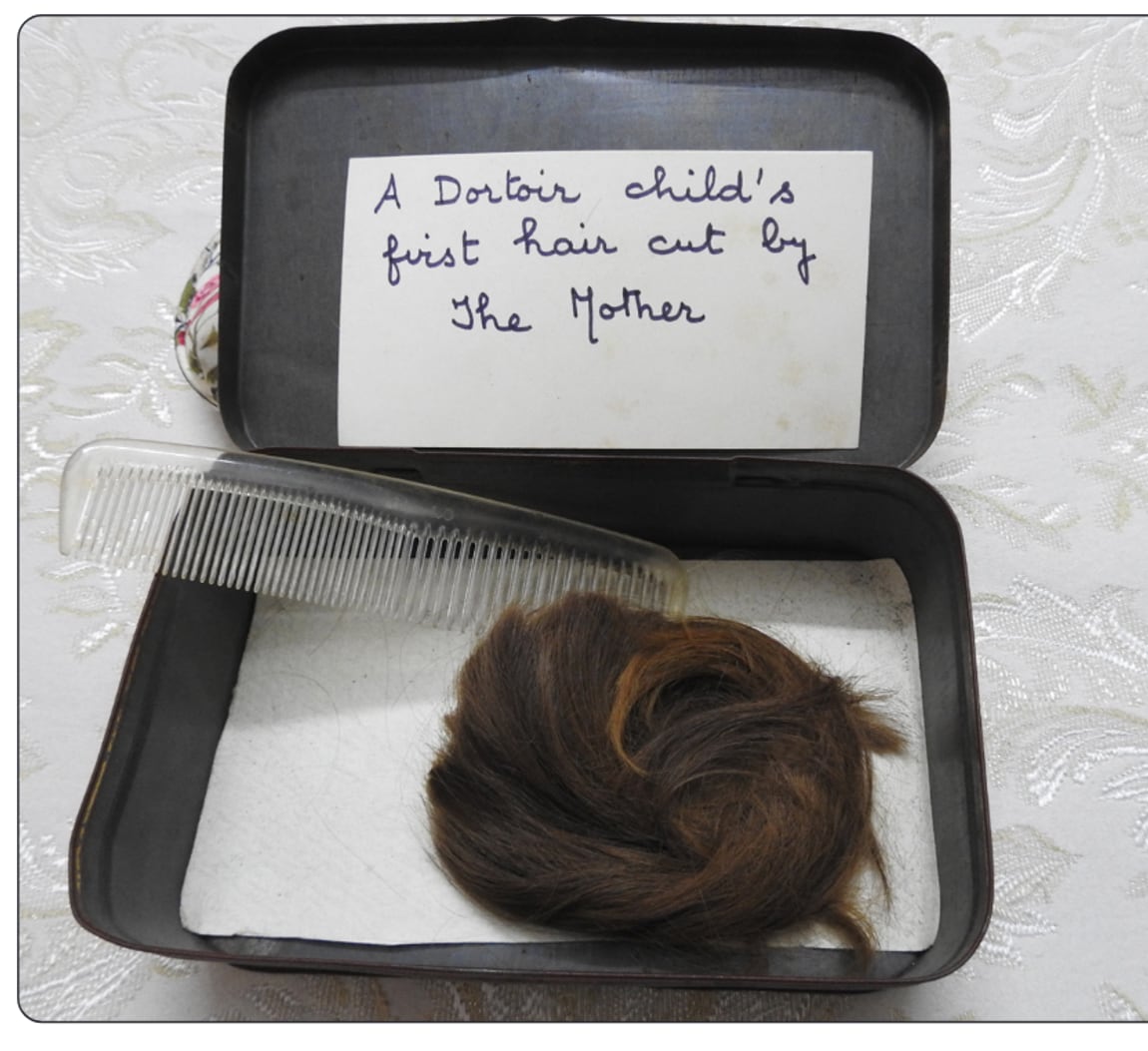 Lock of Promesse&rsquo;s hair cut by the Mother, preserved with a comb in a box
