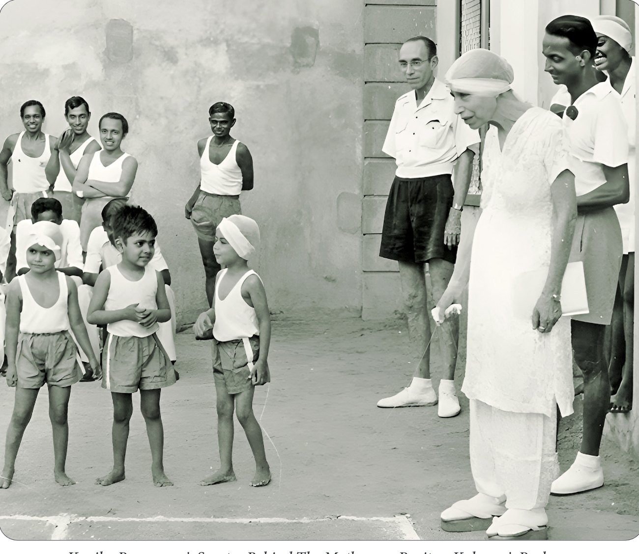 The Mother with children in the Ashram playground; Kapila, Promesse and Samta in front