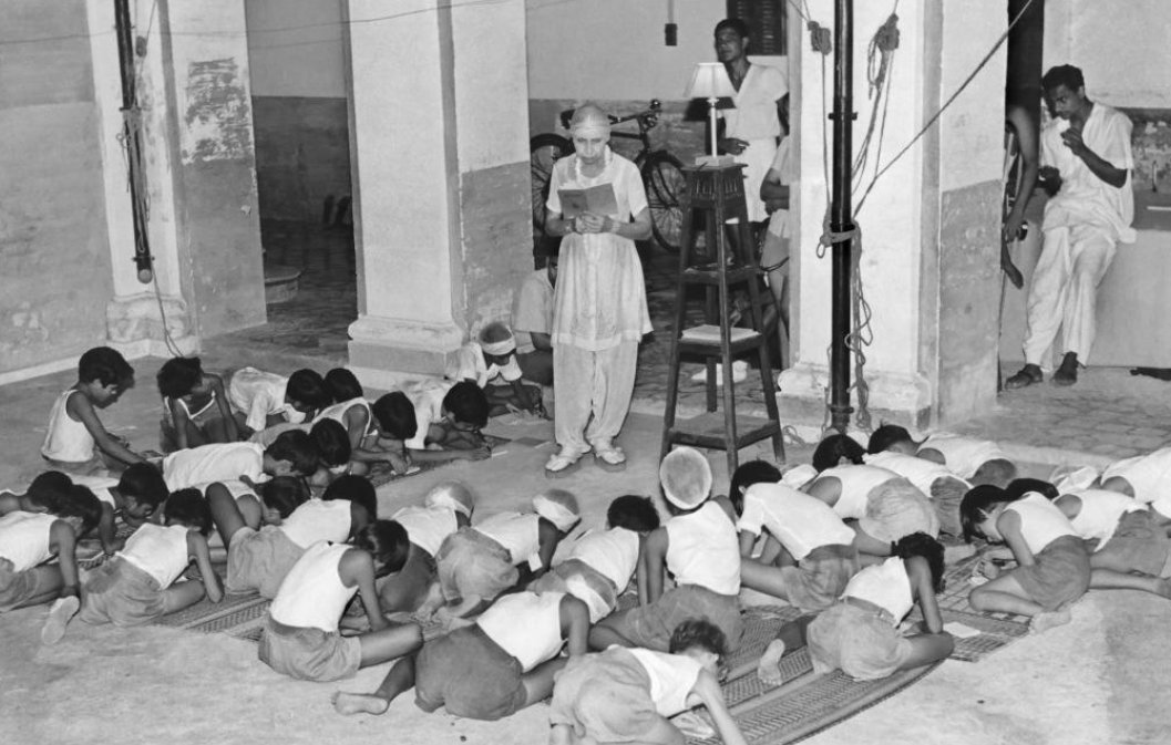 The Mother giving dictation to the children during the class