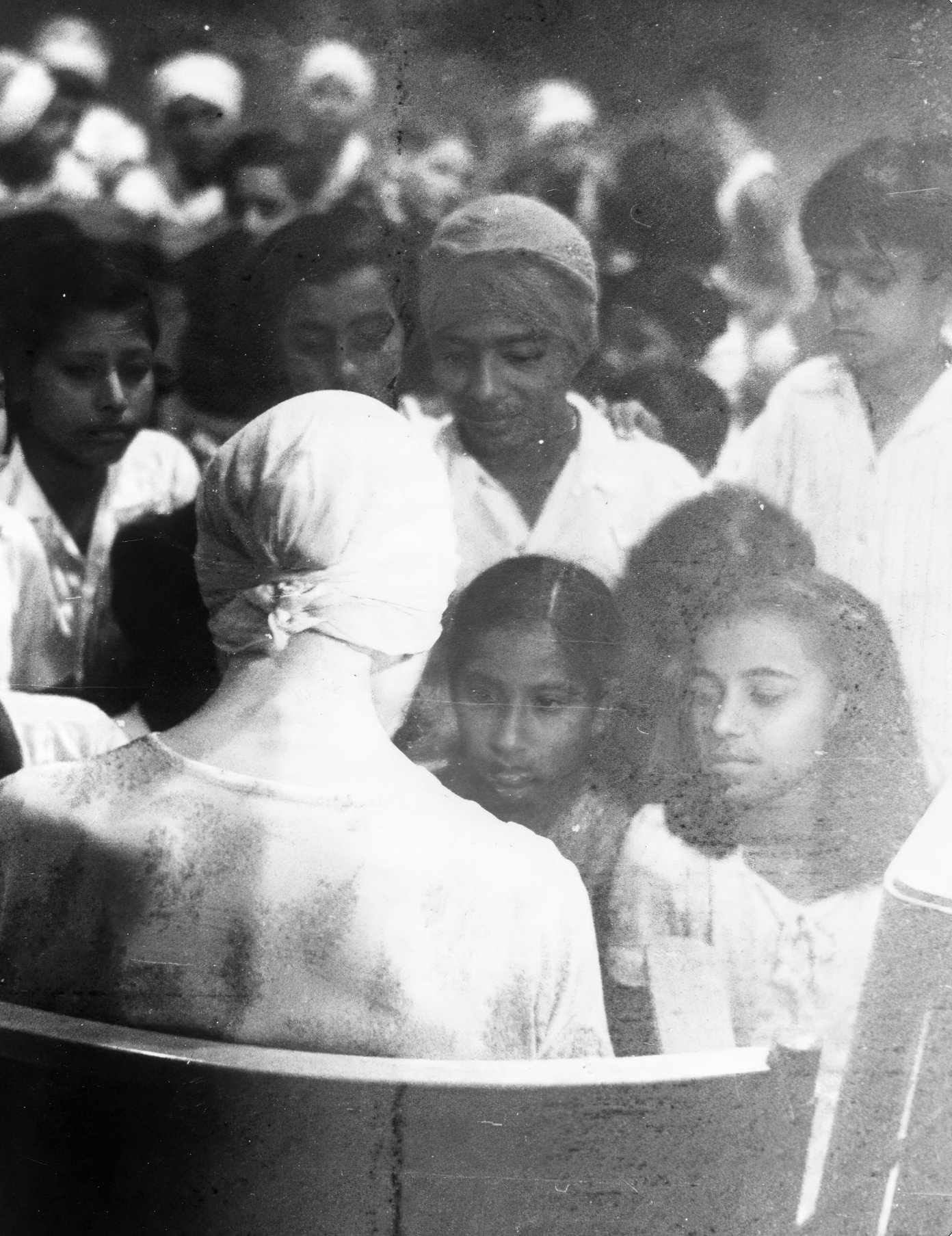 Promesse standing at extreme right, facing the Mother, with other children gathered around Her