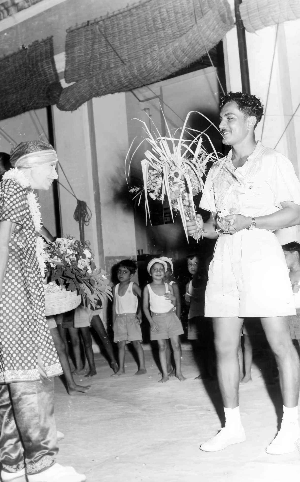 Promesse in the background with The Mother & Pranab-da at the Children's courtyard, on Pranab-da's Birthday, October 18, 1949