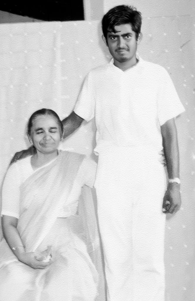 Promesse standing beside his seated mother, Dayawati Jauhar