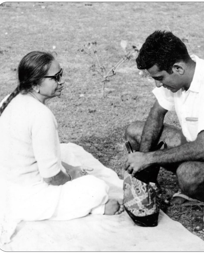 Promesse and his mother sitting together on the grass