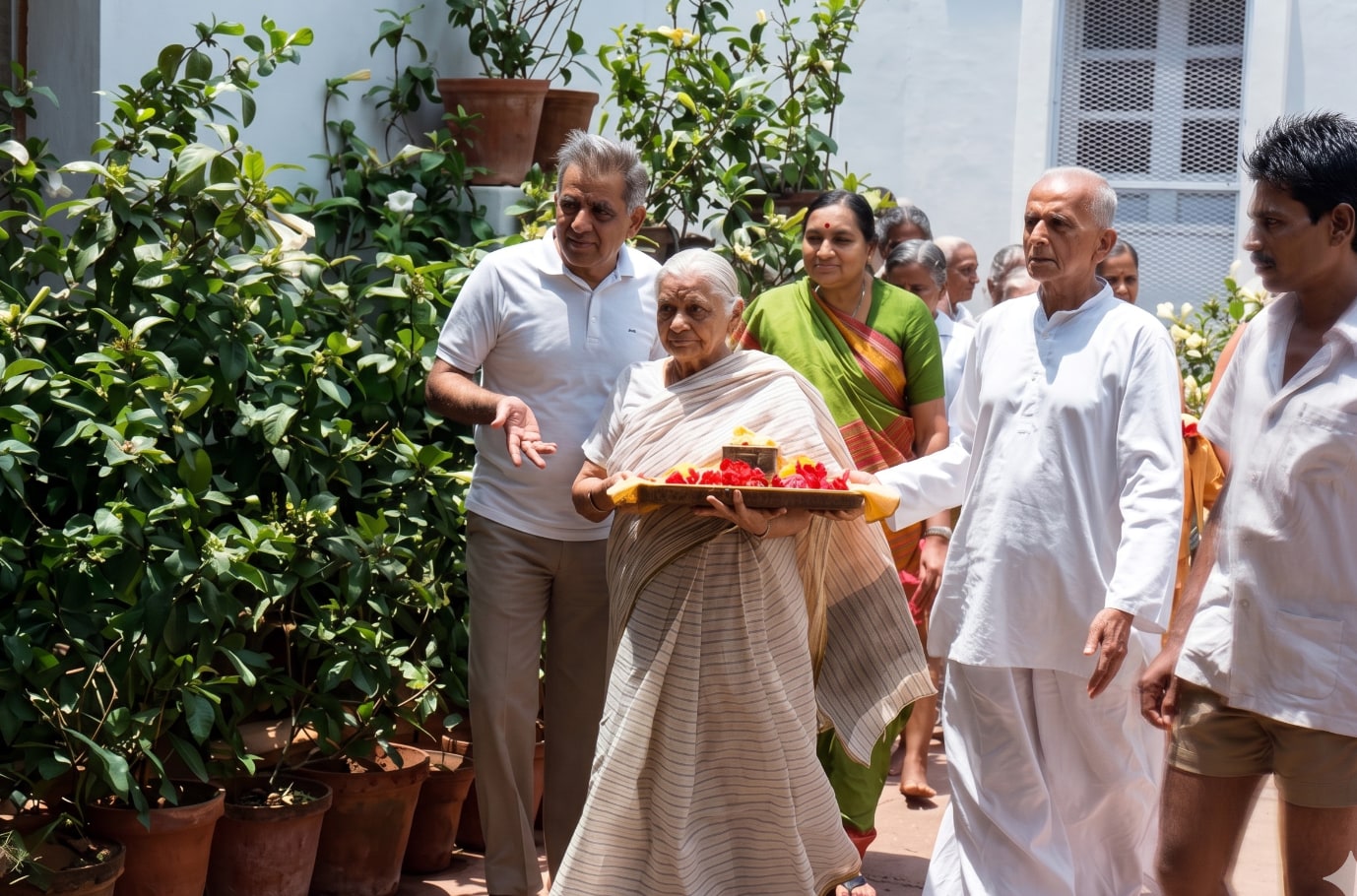 Promesse and his mother carrying Sri Aurobindo's relics in a procession