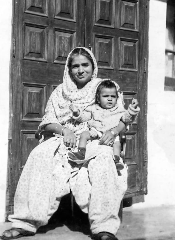Dayawati Jauhar seated with the infant Promesse on her lap