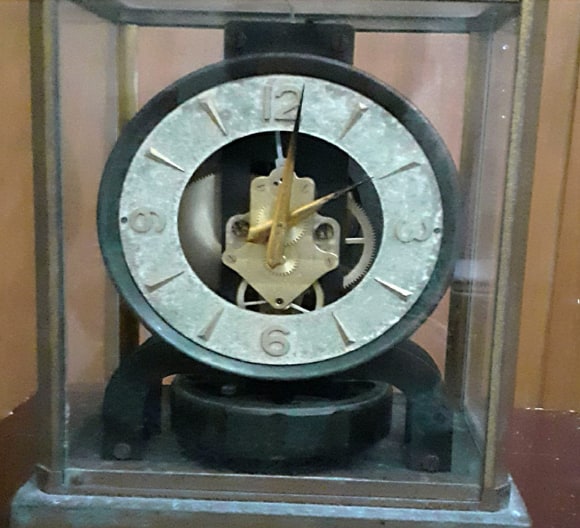 A skeleton clock in a glass case from Promesse's collection